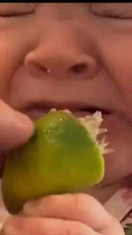 ai character: baby eating lemon background
