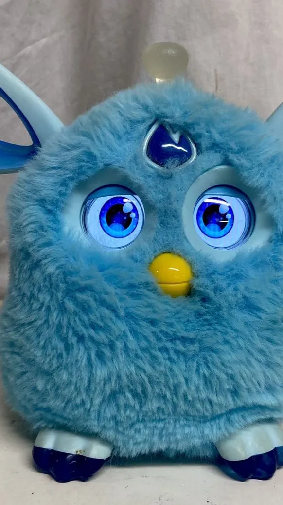 ai character: Blueberry Furby background