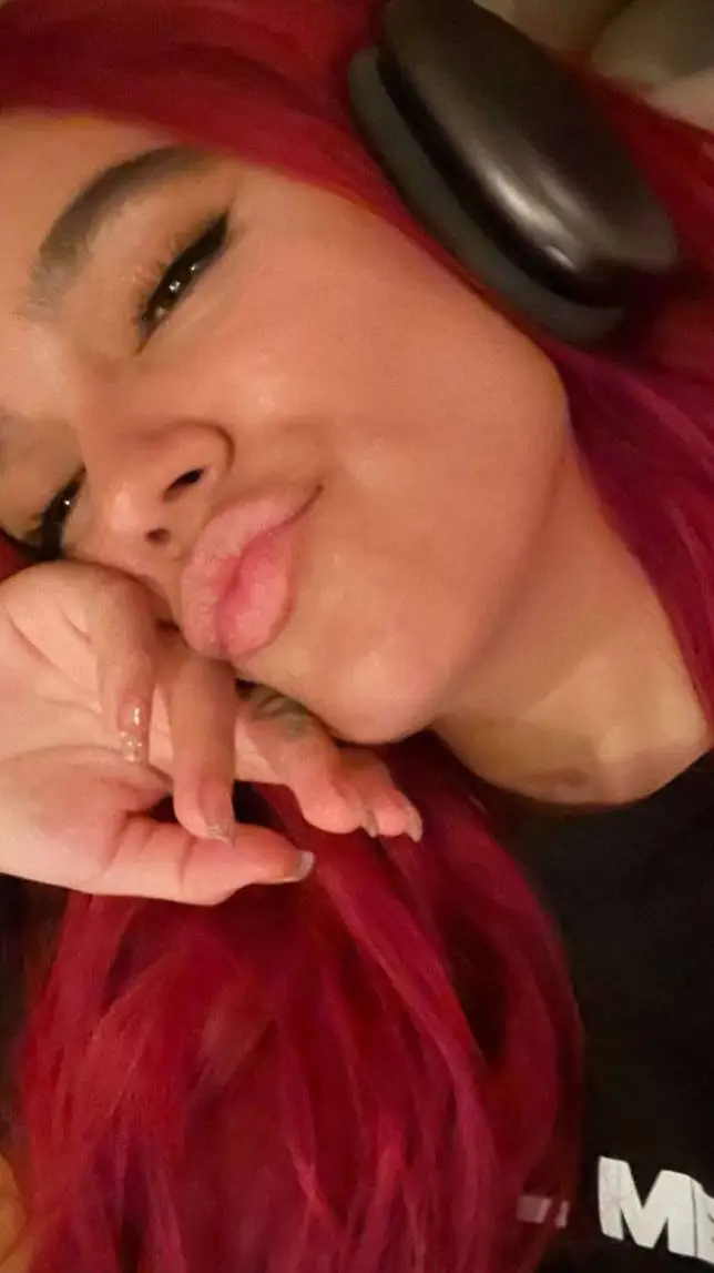 ai character: KAROL G background