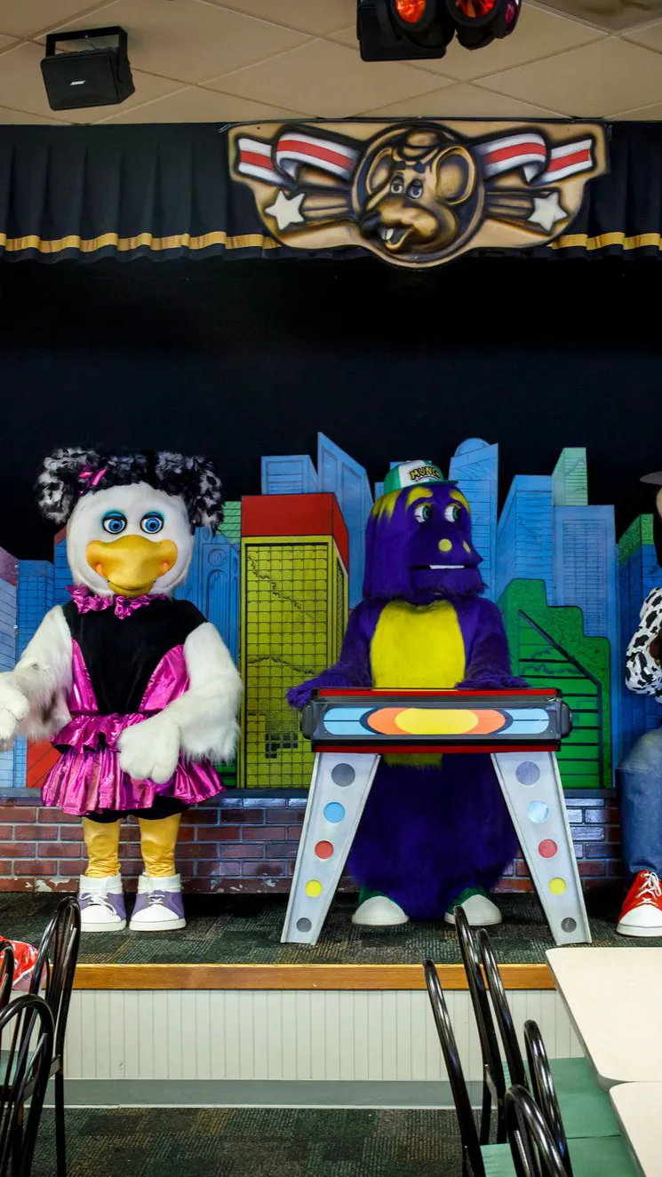 ai character: Chuck E. Cheese  background