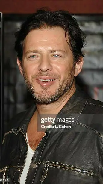 ai character: Costas Mandylor  background