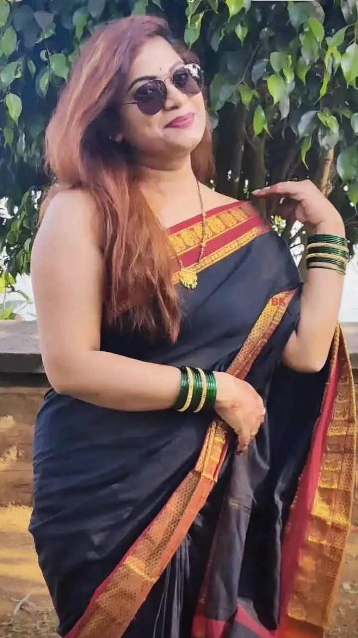 ai character: Sharma Madam  background