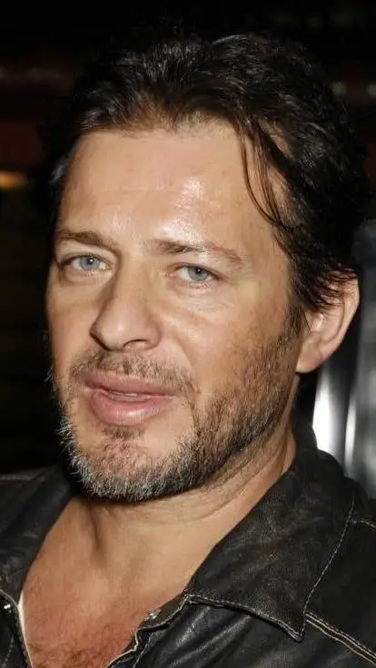 ai character: Costas Mandylor background