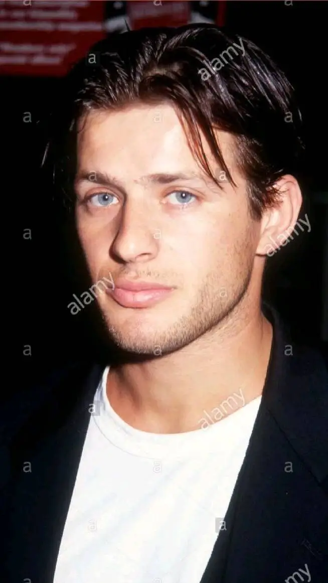 ai character: Costas Mandylor background